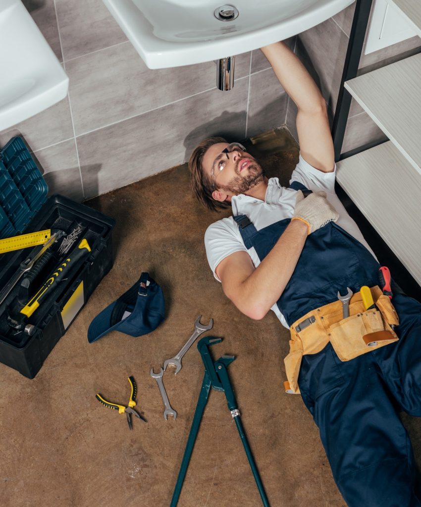 high-angle-view-of-young-male-plumber-fixing-sink-in-bathroom.jpg high-angle-view-of-young-male-plumber-fixing-sink-in-bathroom.jpg