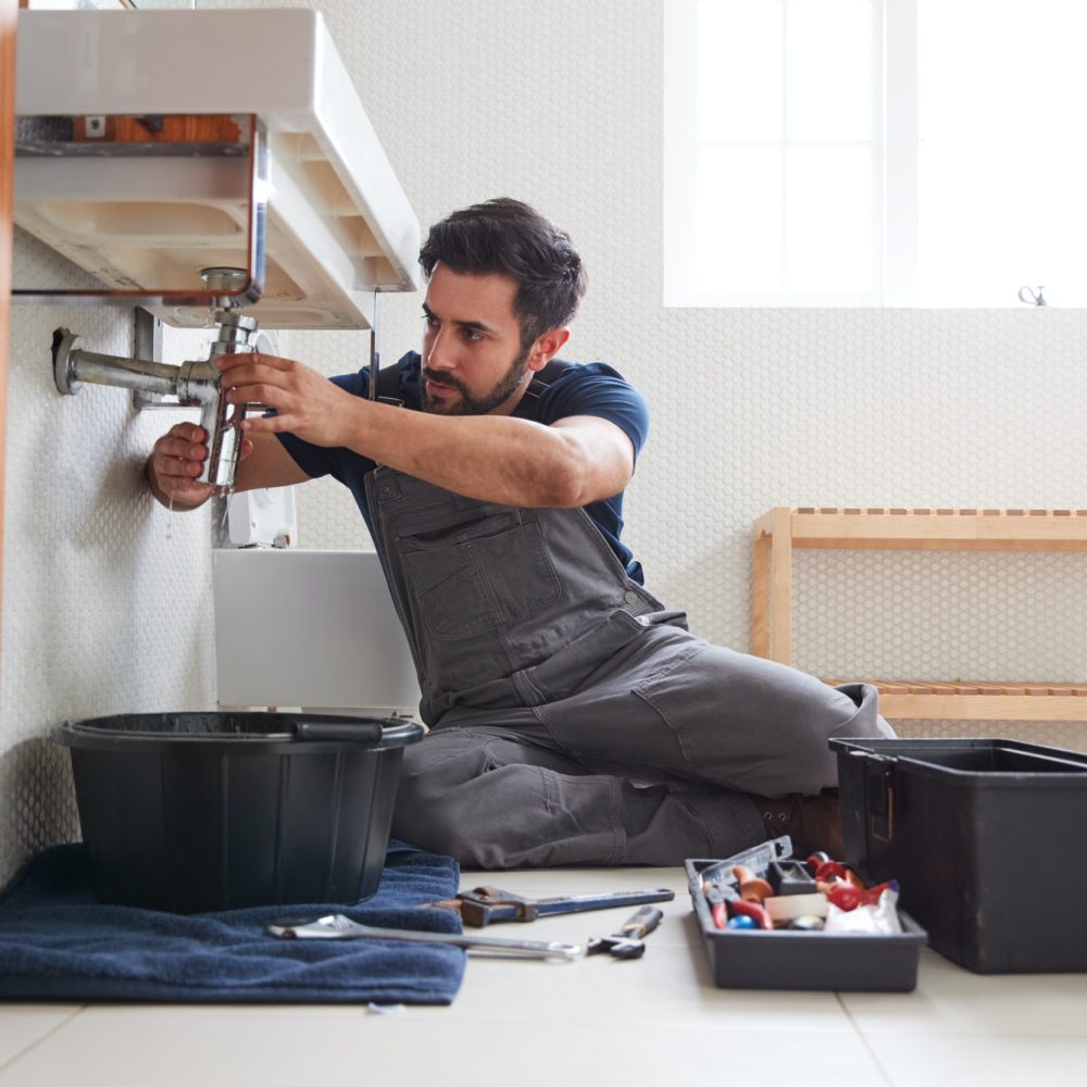 male-plumber-working-to-fix-leaking-sink-in-home-bathroom.jpg male-plumber-working-to-fix-leaking-sink-in-home-bathroom.jpg